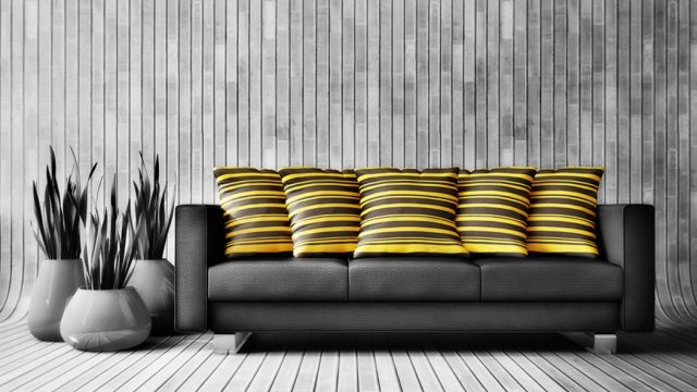 comfortable-black-sofa-and-yellow-hold-pillow-in-grey-living-room.jpg