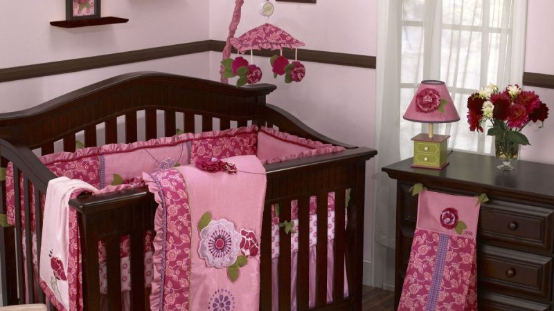 wooden-baby-crib-bed-with-pink-quilt-and-colorful-cushions-pink-inspirations.jpg